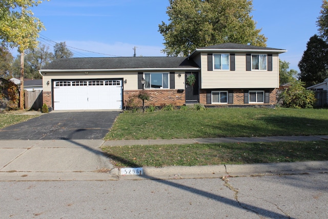 split level home with a garage and a front yard