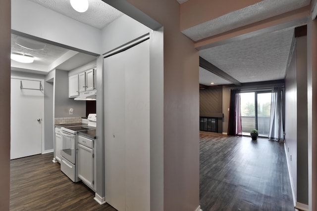 kitchen featuring white cabinets, white electric range, a textured ceiling, and dark hardwood / wood-style flooring