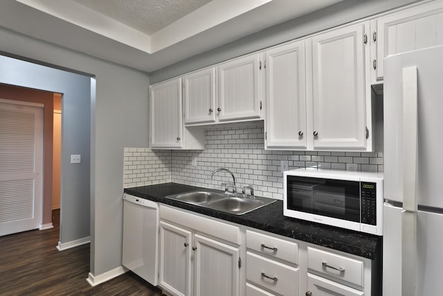 kitchen featuring white cabinets, dark hardwood / wood-style flooring, white appliances, and sink