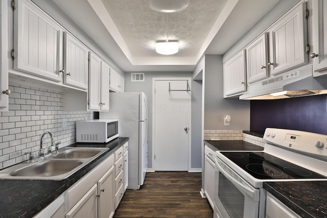 kitchen with white appliances, dark wood-type flooring, sink, a textured ceiling, and white cabinetry