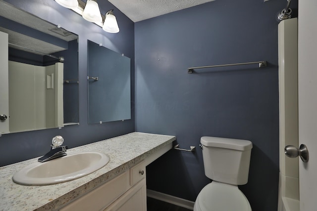 bathroom with vanity, a textured ceiling, and toilet