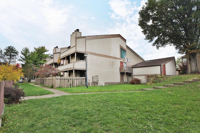 rear view of house with a lawn