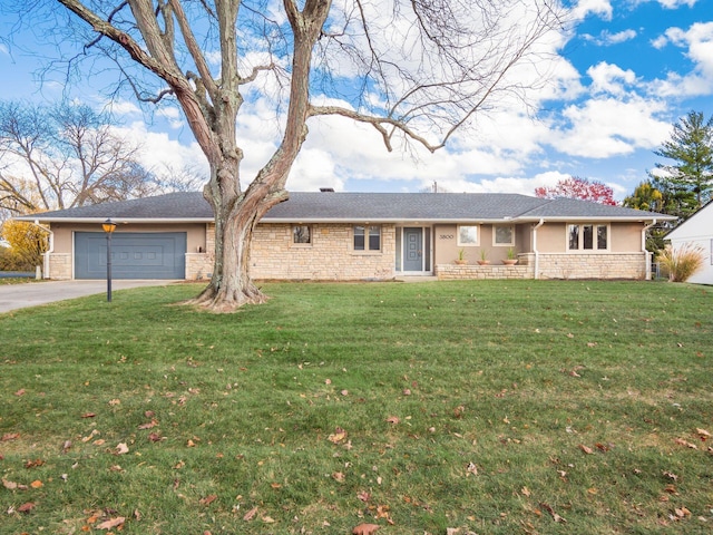 single story home with a garage and a front lawn