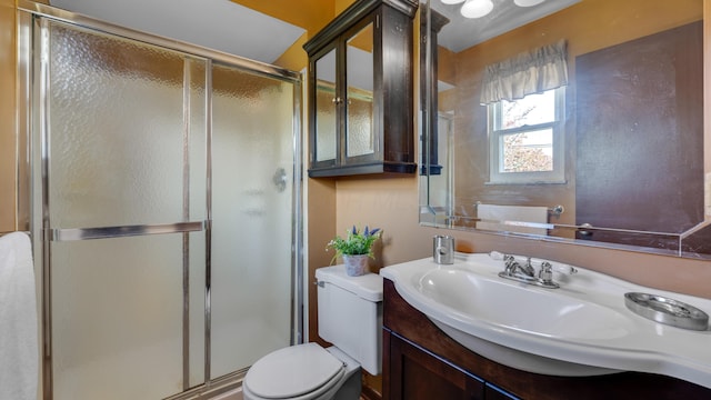 bathroom with vanity, toilet, and walk in shower