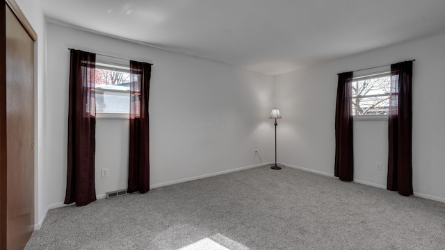 spare room with light colored carpet