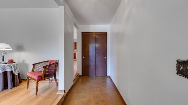 hallway featuring light wood-type flooring and baseboard heating