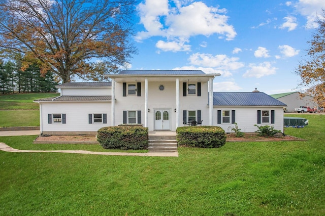 neoclassical / greek revival house featuring a front lawn