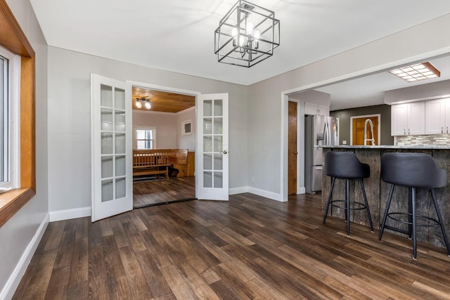 dining area featuring french doors, dark hardwood / wood-style floors, and sink