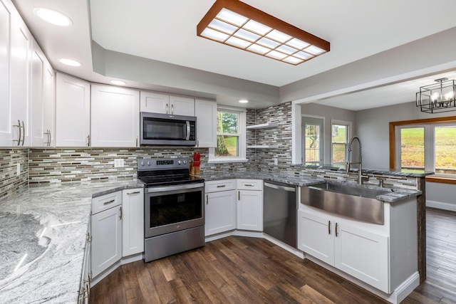 kitchen with sink, dark hardwood / wood-style flooring, white cabinets, and appliances with stainless steel finishes