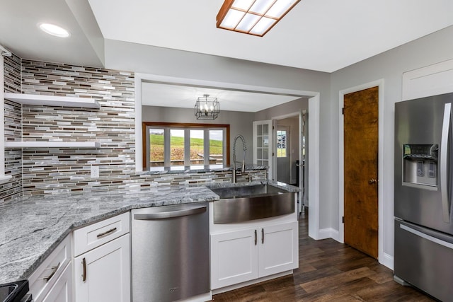 kitchen featuring white cabinets, appliances with stainless steel finishes, dark hardwood / wood-style floors, and sink