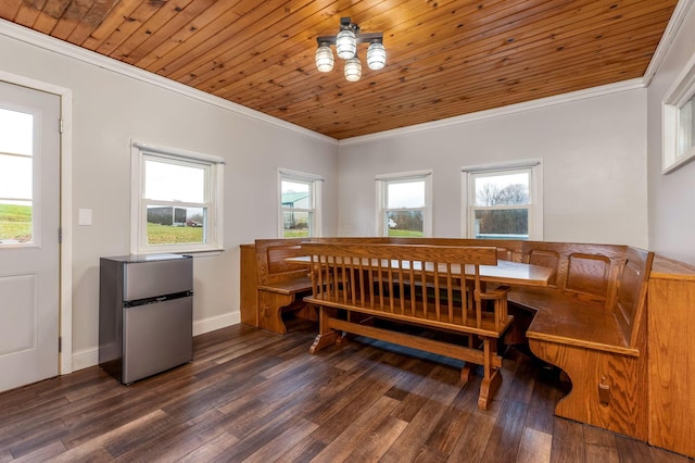 dining space featuring ornamental molding, dark hardwood / wood-style flooring, and wooden ceiling