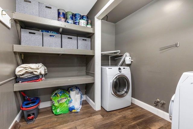 washroom with washer / dryer and dark hardwood / wood-style floors