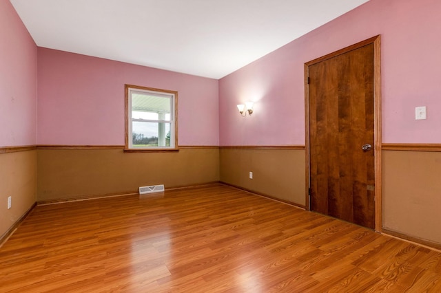 unfurnished room with light hardwood / wood-style floors