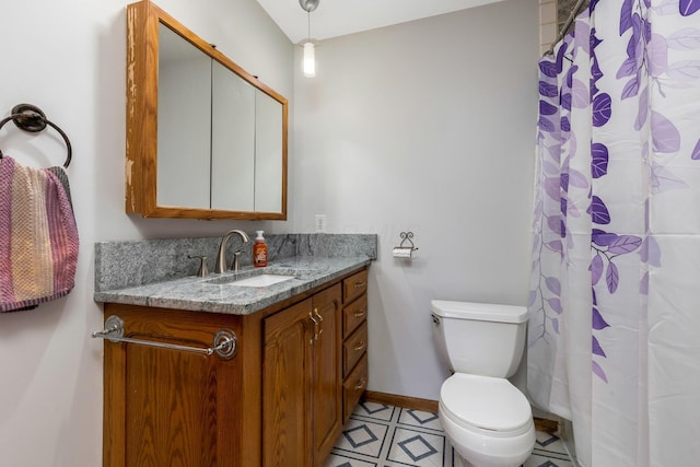 bathroom featuring tile patterned flooring, vanity, curtained shower, and toilet