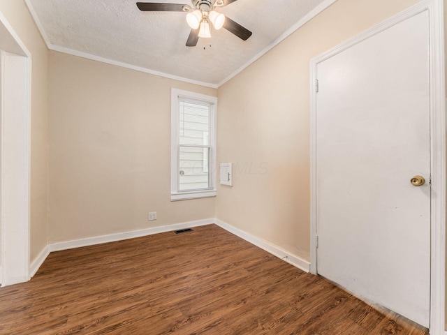 unfurnished room featuring ornamental molding, a textured ceiling, and dark wood-type flooring