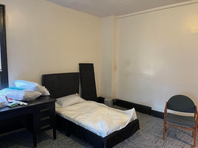 carpeted bedroom featuring a textured ceiling