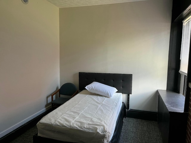 carpeted bedroom with a textured ceiling