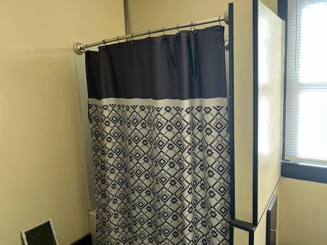 bathroom with a shower with shower curtain