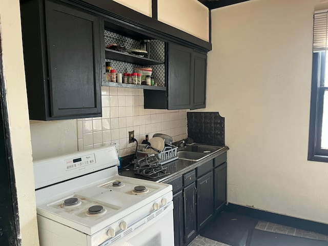 1423 E Main St, Columbus, OH 43205 - kitchen with white range with electric stovetop, tasteful backsplash, open shelves, and dark tile patterned floors