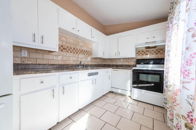 kitchen with white cabinets, white appliances, vaulted ceiling, and backsplash