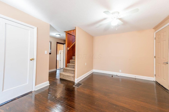 empty room featuring ceiling fan and dark wood-type flooring