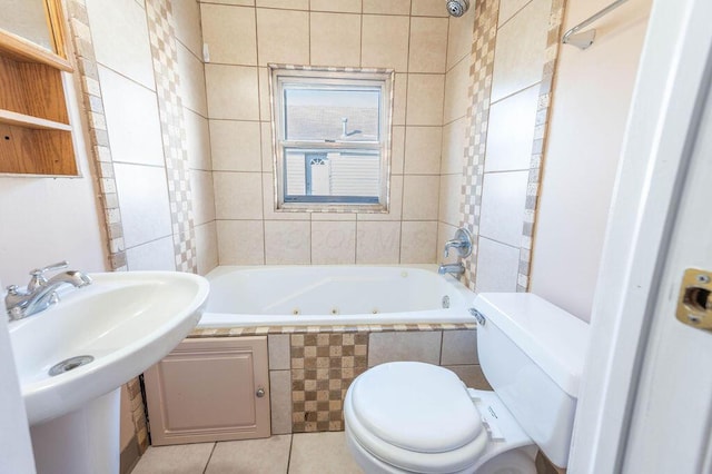 bathroom featuring tile patterned flooring, toilet, tile walls, and sink