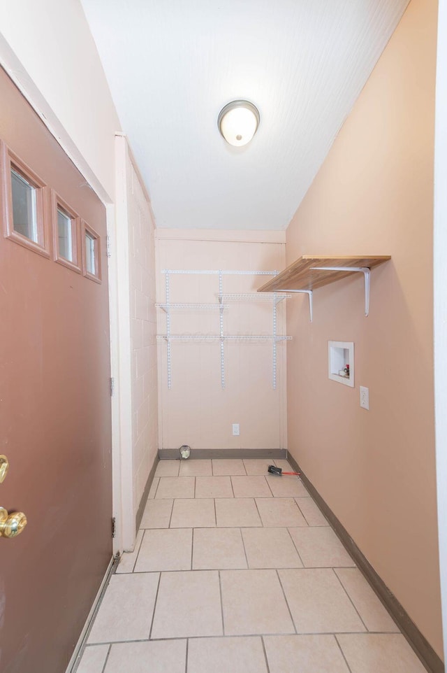 washroom featuring hookup for a washing machine and light tile patterned flooring