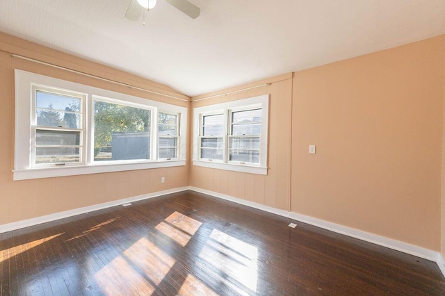 spare room with dark hardwood / wood-style flooring, ceiling fan, and lofted ceiling