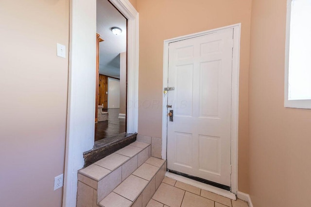 doorway featuring light tile patterned floors