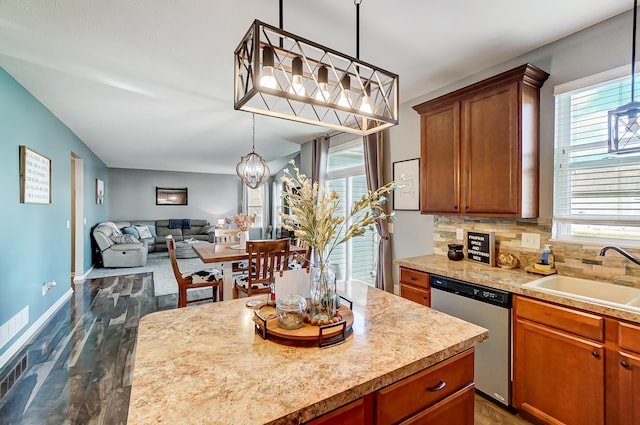 kitchen featuring decorative backsplash, dishwasher, sink, and dark hardwood / wood-style floors