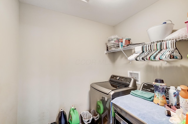 clothes washing area featuring separate washer and dryer