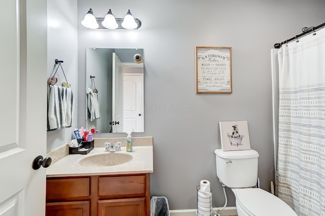 bathroom with vanity, toilet, and walk in shower