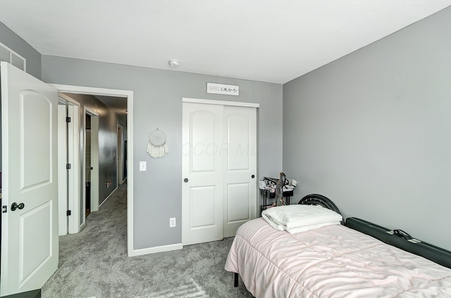 bedroom featuring a closet and light colored carpet