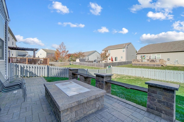 view of patio / terrace with a wooden deck and a fire pit