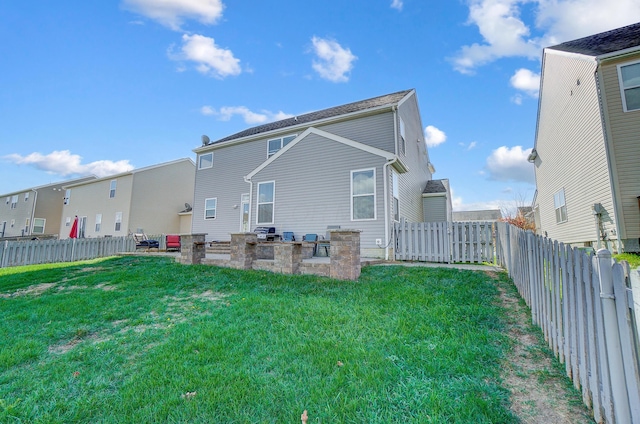 back of house featuring a patio area and a yard