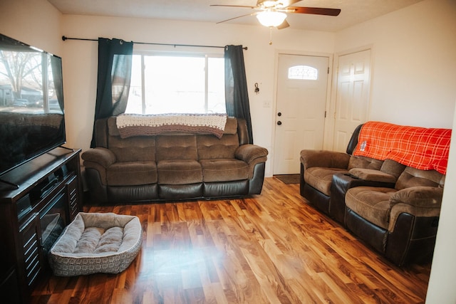 living room featuring hardwood / wood-style flooring and ceiling fan