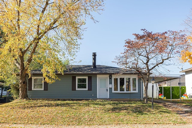 view of front facade featuring a front lawn and a carport