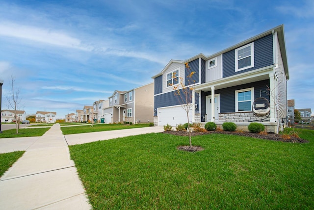 view of front of property with a garage and a front lawn