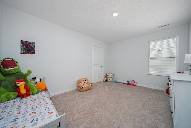 carpeted bedroom with a textured ceiling