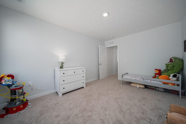 carpeted bedroom featuring a textured ceiling