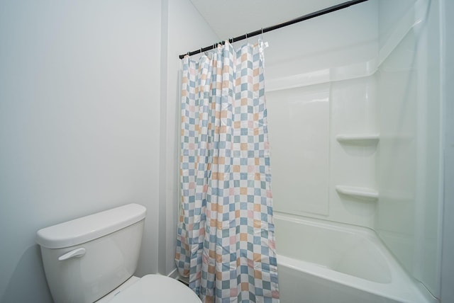 bathroom with toilet and shower / bath combo with shower curtain