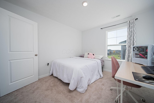 bedroom with light colored carpet