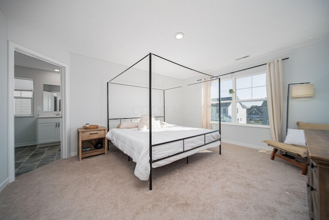 carpeted bedroom with ensuite bathroom