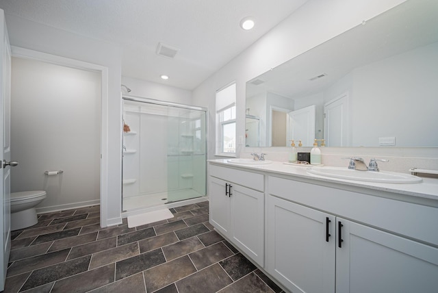 bathroom with vanity, an enclosed shower, and toilet