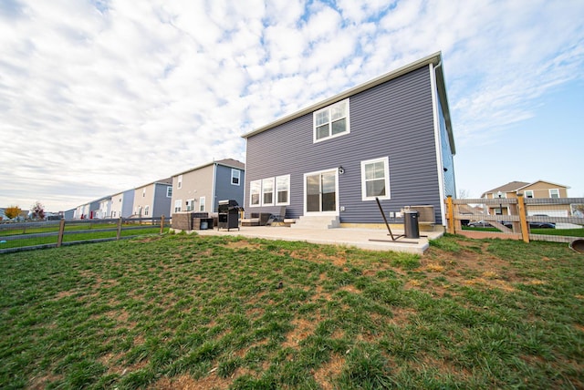 rear view of house with a yard and a patio area