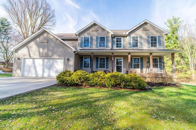 traditional-style house featuring driveway, a front yard, covered porch, and an attached garage