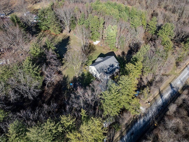 birds eye view of property featuring a view of trees