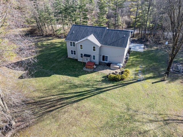 birds eye view of property featuring a wooded view