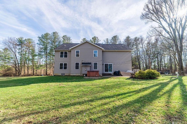 rear view of house featuring a lawn