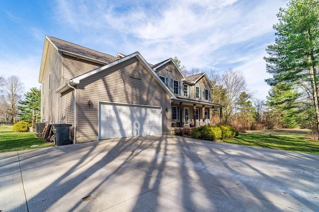 view of home's exterior with covered porch, concrete driveway, a lawn, and a garage